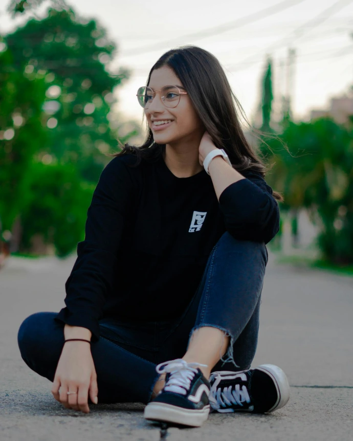 a woman sitting on the ground with her legs crossed